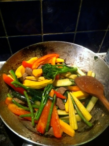 wok with vegetables and beef stirfrying